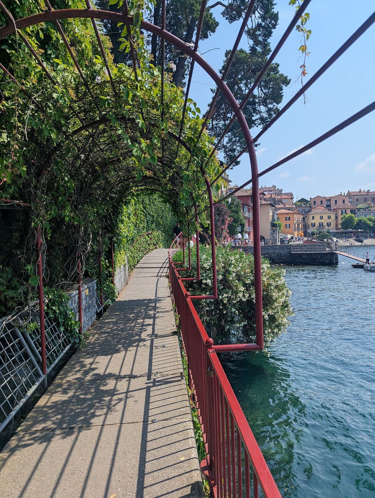 A lakeside walkway under a vine arbor in Varenna, Italy